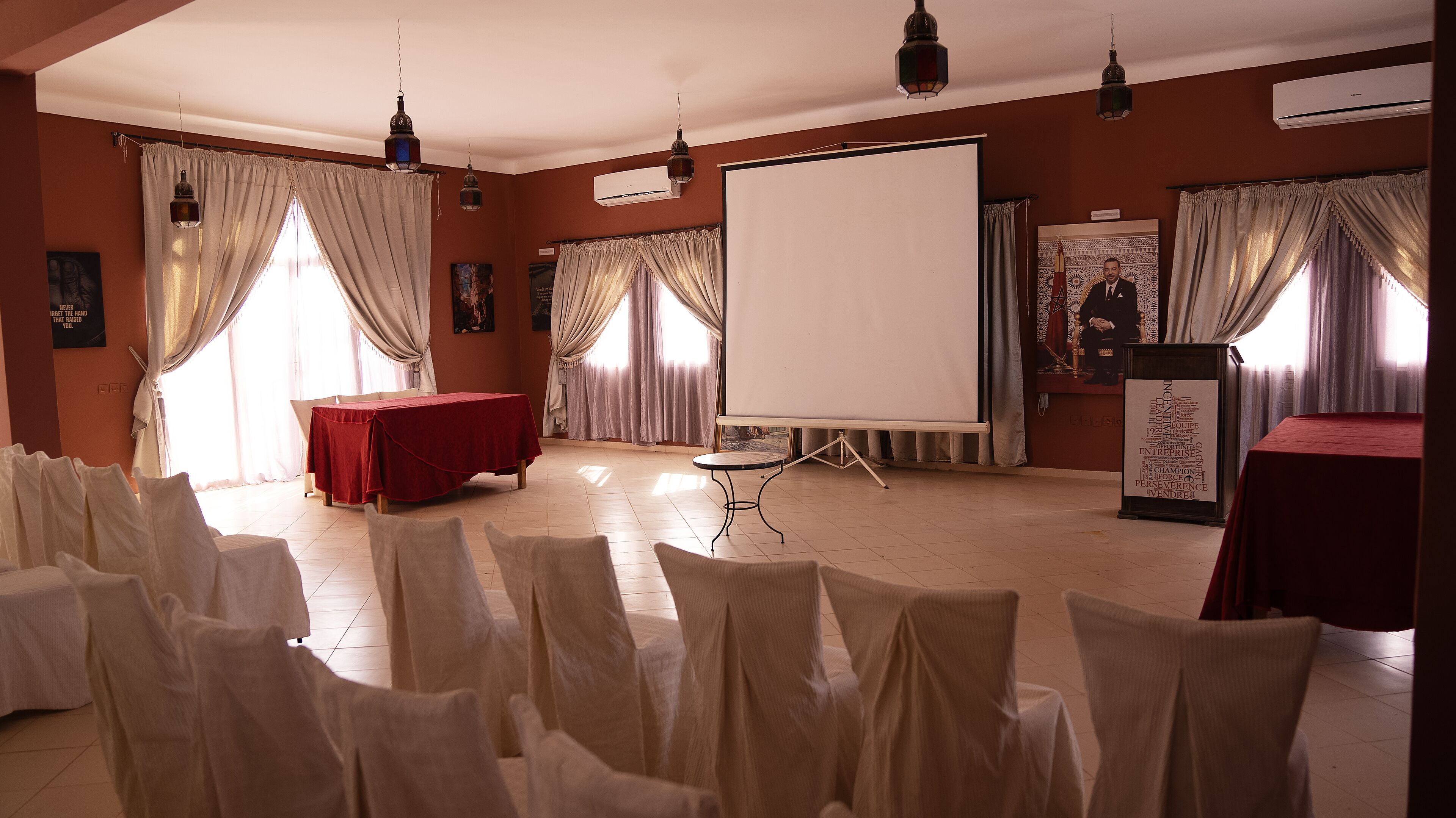 A conference room with a whiteboard, a projector, and a podium.
