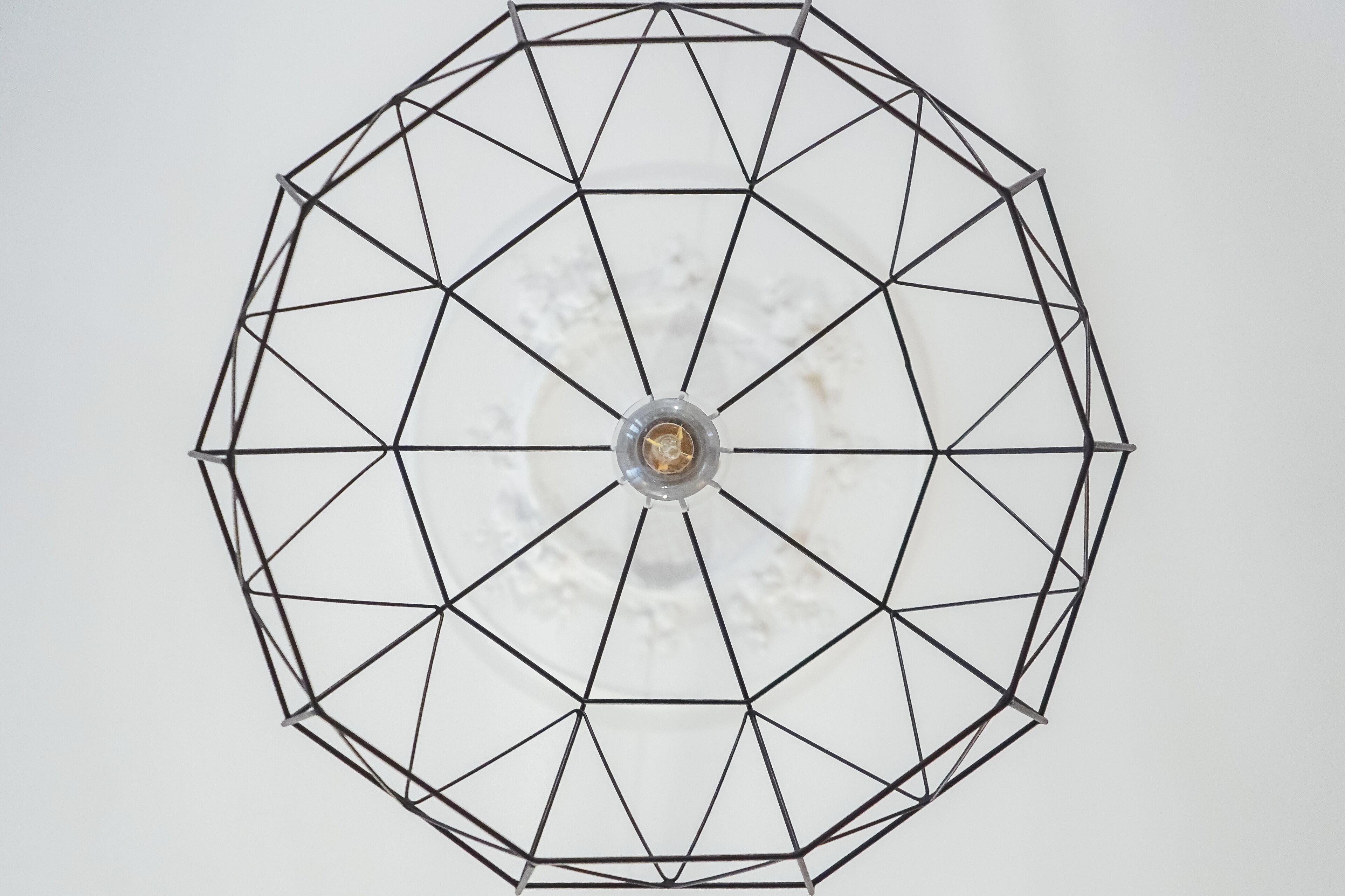 A geometric metal structure with a central light fixture.