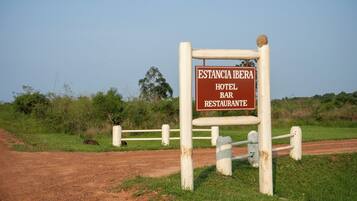 A sign for Estancia Ibera Hotel Bar Restaurant.