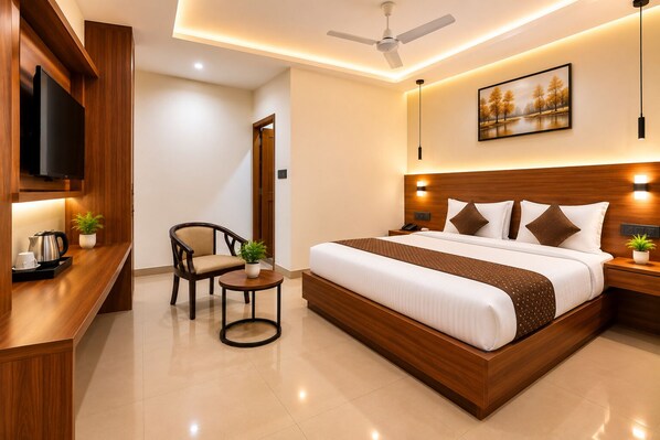 A modern hotel room with a bed, bedside table, chair, and a television.