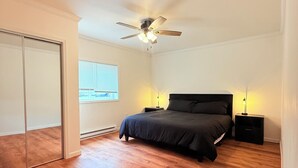 A bedroom with a bed, a ceiling fan, a nightstand, and a window. - 2Bed1 bath Near Ithaca &Cornell lower unit (Locke)