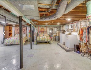 Cozy retreat with a bed, washing machine, and ample storage for your belongings.