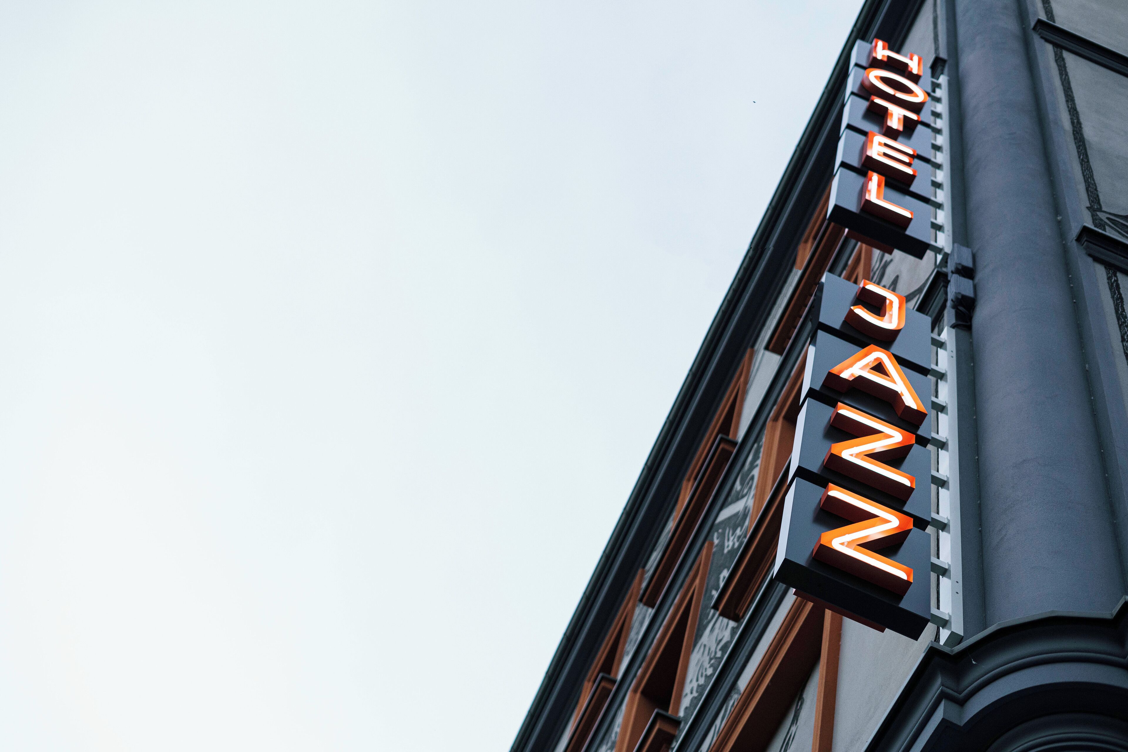 A hotel sign with the name "HOTEL ZANNIN" in illuminated letters.