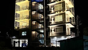 A multi-story building with balconies and a sign that reads "SOLITUDE". - SOLITUDE (Dharamshala)