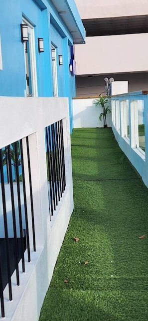 Stylish building with a blue facade, white accents, and a well-manicured outdoor space.