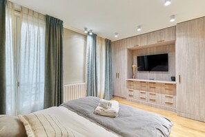 Laptop workspace, iron/ironing board, bed sheets