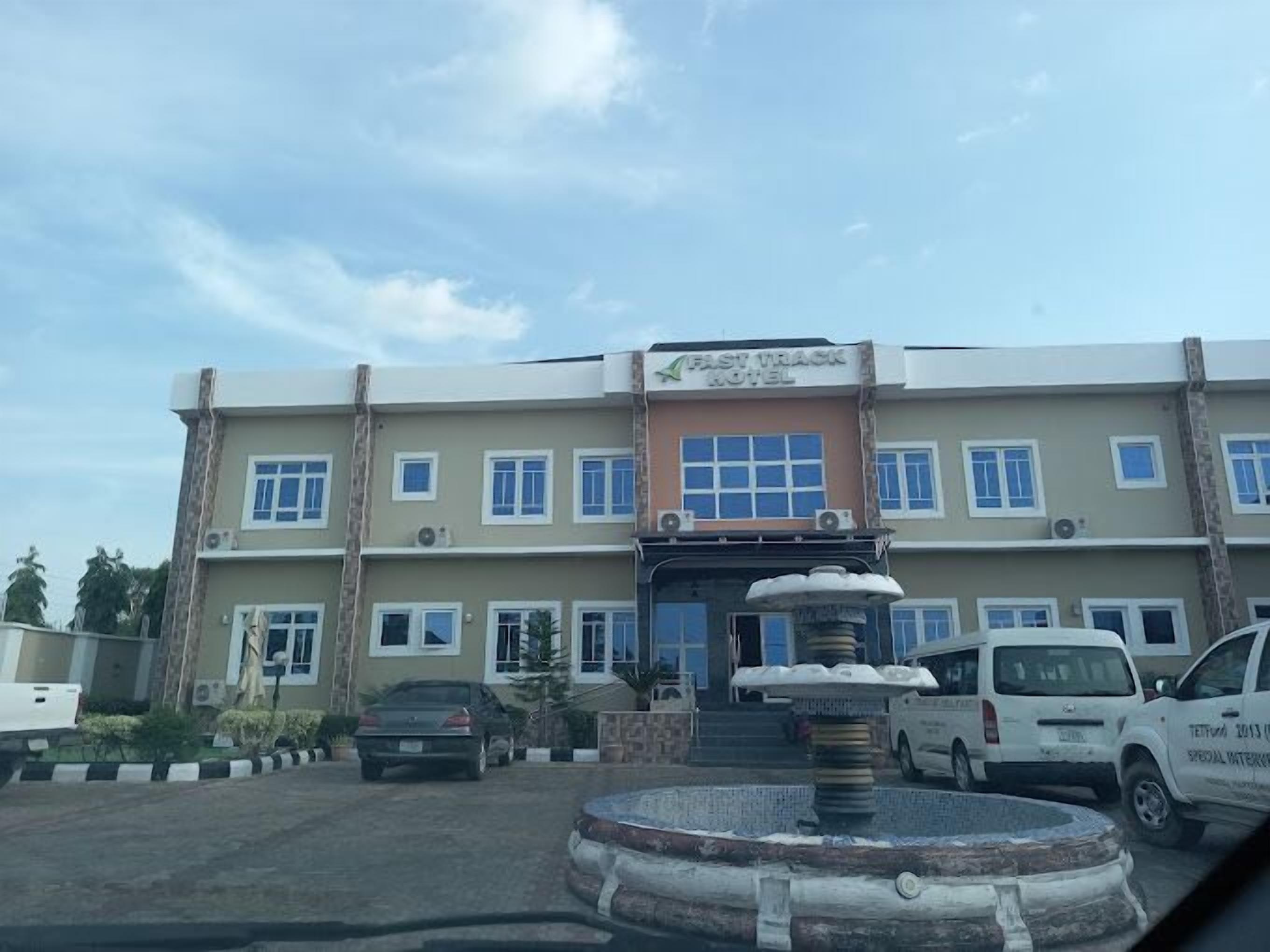 A hotel building with a sign reading "Fast Track Hotel".