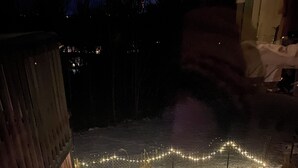 A snow-covered outdoor area with a wooden deck and string lights. - Cozy SAFE 1 BR Private apartment Traveling Professionals near skiing Hospitals (Exeter)