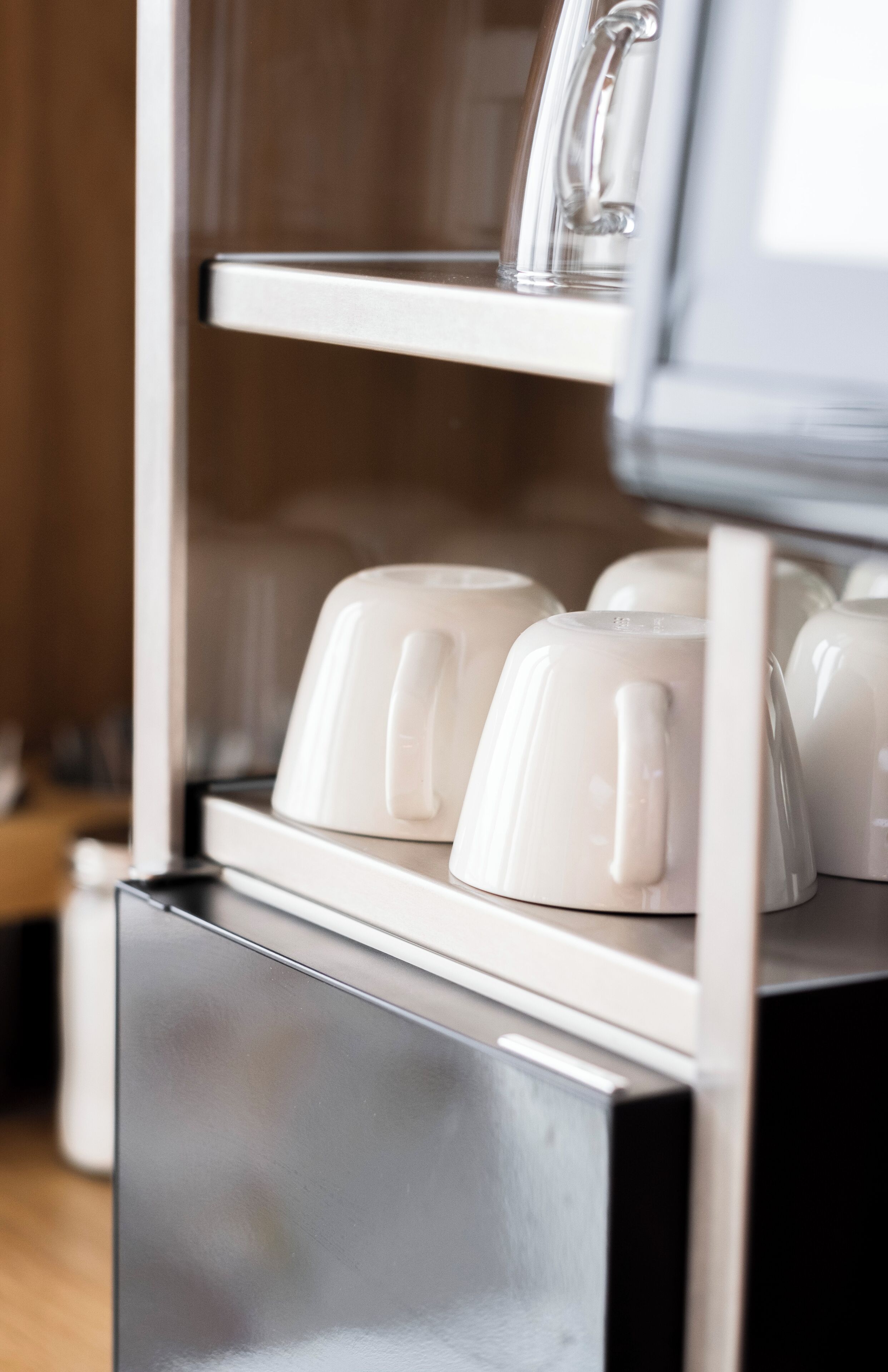 A coffee machine with multiple cups and a spoon.
