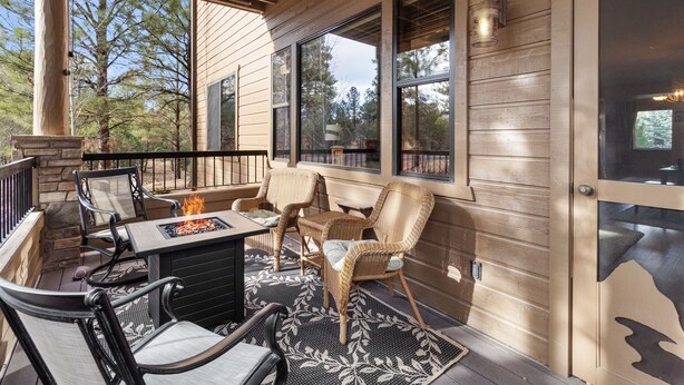 An outdoor patio with a fire pit, wicker chairs, and a table. - *NEW* Mooseberry Villa • King Bed • eBikes • Nearby Fool Hollow Lake • Torreon (Show Low)