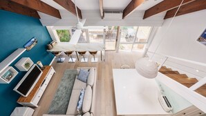 A modern interior with a dining area, sofa, and kitchen. - Pet Friendly - Captain Sandy on the Loop Blairgowrie (Blairgowrie)