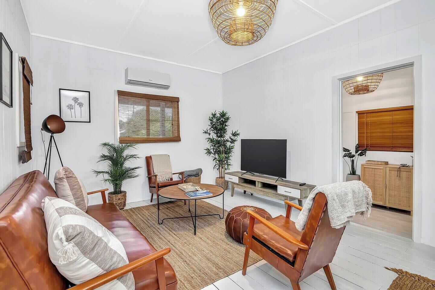 The living area offers a sofa and a TV to relax with a movie, and split system air conditioning ensures year-round comfort.