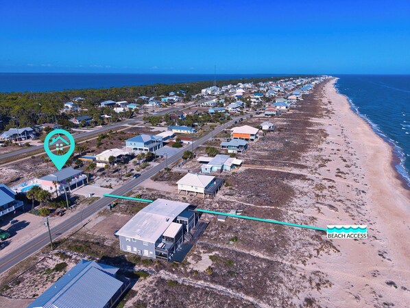 A coastal residential area with houses, a beach, and a marked location. - Life's A Beach - Pet Friendly, Private Pool, Beach Views, Across from Beach! (St George Island)