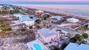 An aerial view of a coastal residential area with houses, a swimming pool, and a beach. - Life's A Beach - Pet Friendly, Private Pool, Beach Views, Across from Beach! (St George Island)