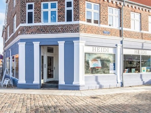 A corner building with a shop named 'HEIDI' on the ground floor.