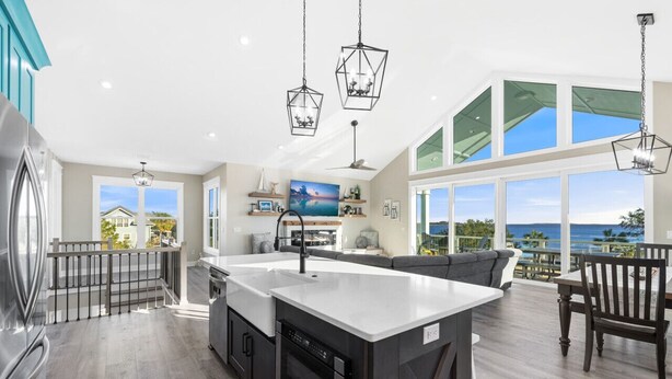 A modern kitchen with a large island, built-in appliances, and a view of the ocean. - Amazing Gulf views ~ 4 bedrooms ~ Brand new home ~ Great for families (Cedar Key)