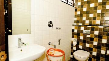 A bathroom with a white sink, a toilet, and a mirror.