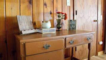 A wooden dresser with drawers and a small table on top.