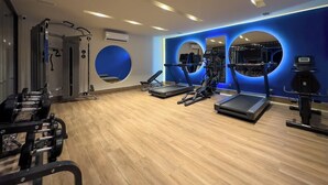 A gym with treadmills, elliptical machines, and weightlifting equipment.