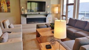 A modern living room with a flat-screen TV, sofa, and coffee table. - SPRING BREAK- SLOPESIDE Luxury Ski-in/Ski-out- Grand Colorado Peak 8 - SLEEPS 12 (Breckenridge)