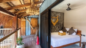 A bedroom with a wooden bed, a large window, and a ceiling fan. - Meteora Stay & Co-Working Space (Tulum)
