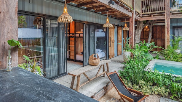 A wooden deck with a pool, a bench, and a lounge chair. - Meteora Stay & Co-Working Space (Tulum)