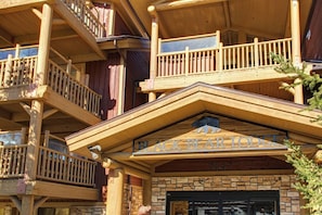 A wooden building with a sign reading 'Black Bear Lodge' and the number '7447'.