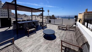A rooftop terrace with outdoor seating, a pergola, and a view of the sea. - Centro Historico on the Malecon Boardwalk (Mazatlan)