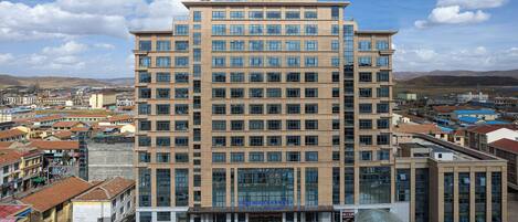 Edificio de un Days Hotel con fachada de vidrio moderna, varios pisos y techo plano.