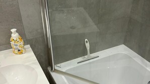 A modern bathroom with a white sink, a glass shower enclosure, and a white bathtub. - Brabank 457 BestView by Grand Apartments (Gdansk)