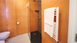 A bathroom with a toilet, a shower, and a towel rack. - Venice Suite. Becoloured, where it is possible to dream among art masterpieces. (Napoli)