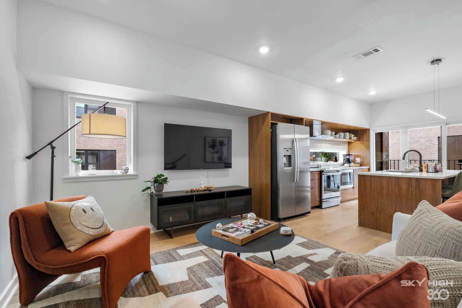 A modern living room with a sofa, a coffee table, and a TV.
