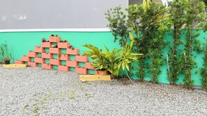 Stunning green wall with a pyramid of planters, featuring a variety of lush plants.