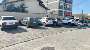 A parking lot with several cars parked in front of a building with a sign that reads "ENERGIZE".