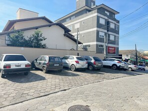 A parking lot with several cars parked in front of a building with a sign that reads "ENERGIZE".