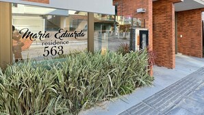 A modern building with a sign reading "Maria Eduardo residence 563".
