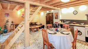 A cozy wooden interior with a dining area, kitchen, and staircase. - Gorgeous home in Rochessauve with WiFi (Rochessauve)