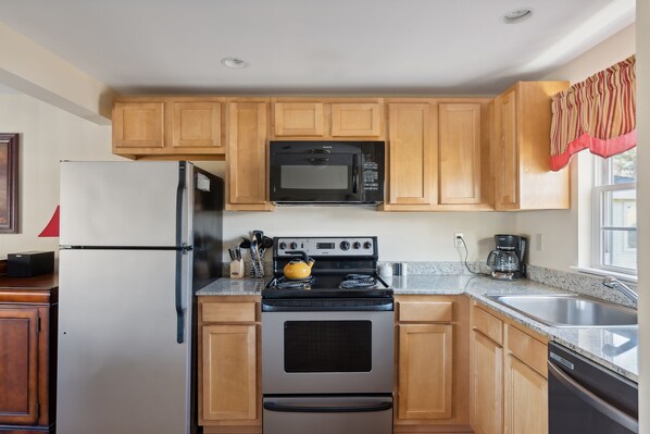 A kitchen with wooden cabinets, a refrigerator, a stove, a microwave, and a sink. - RARE 3 Bedroom at the Resort at Goose Rocks Beach (Kennebunkport)