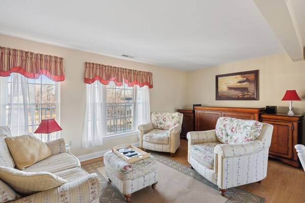 A living room with two armchairs, a sofa, a coffee table, and a fireplace. - RARE 3 Bedroom at the Resort at Goose Rocks Beach (Kennebunkport)