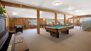 A spacious indoor recreational area with a pool table, a pool table, a piano, and wooden walls. - RARE 3 Bedroom at the Resort at Goose Rocks Beach (Kennebunkport)