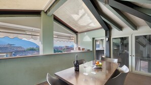 A dining area with a table, chairs, a bottle, and glasses. - Holiday Apartment "Viasambuco" with Private Terrace & Wi-Fi (Iseo)