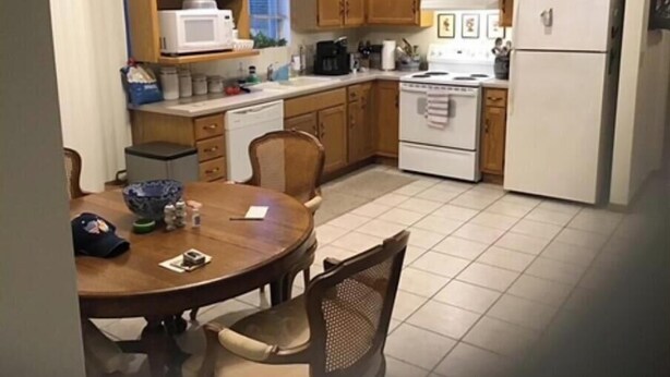 A kitchen with wooden cabinets, a stove, a microwave, and a refrigerator.