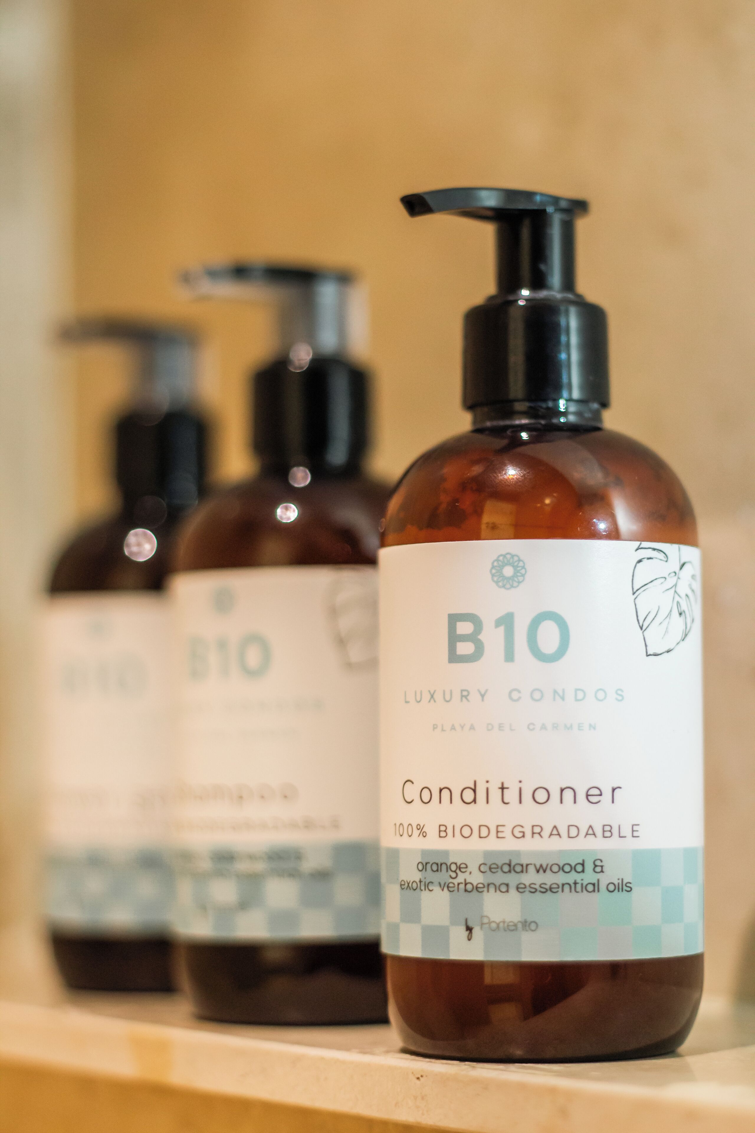 Three bottles of B10 Luxury Condos conditioner on a shelf.