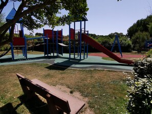 Children can play on the playground's climbing frames and slide.