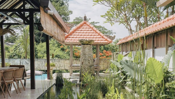 A serene garden with a pool, wooden deck, and a gazebo. - Tropical Villa Asmara (Ungasan)