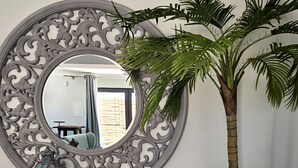 A room with a large ornate mirror, a wooden bench, a potted plant, and a lantern. - Walking distance to several beaches, Ferragudo village, supermarkets and Portimão. (Ferragudo)