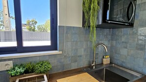 A modern kitchen with a wooden countertop, a sink, and a window with blinds. - Walking distance to several beaches, Ferragudo village, supermarkets and Portimão. (Ferragudo)