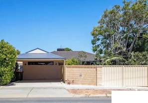 A residential property with a garage, a fenced yard, and a tree. - Private and Secure, 3 bed 1.5 bath (Kardinya)