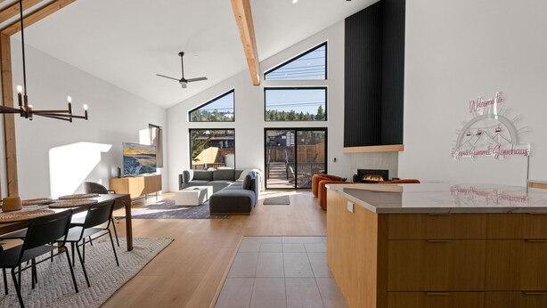 A modern kitchen with a wooden island, large windows, and a view of the outdoors. - Brand New Gorgeous home in fantastic Big Bear Lake right on Snow summit Resort! (Big Bear Lake)