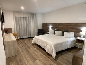 Desk, laptop workspace, blackout drapes, iron/ironing board